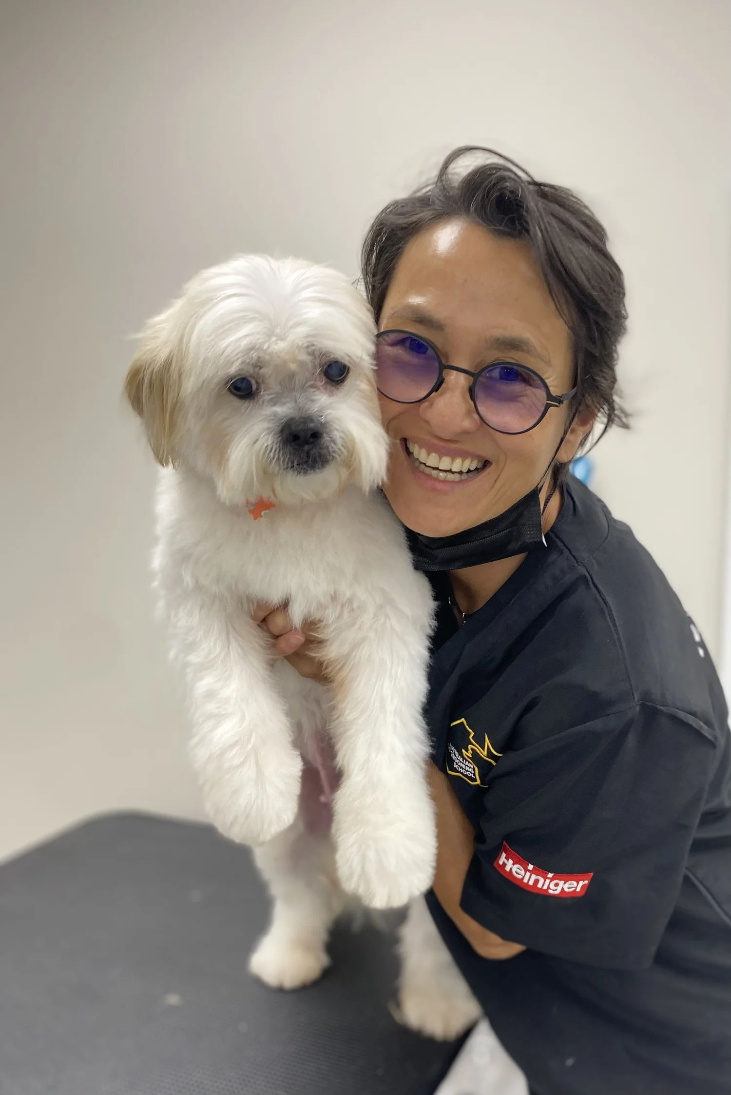 Jax, the groomer at Wag & Bone, with a happy dog